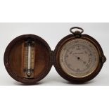 An early 20th century leather cased pocket compensated barometer/thermometer/compass compendium, the