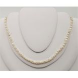 A cultured pearl choker necklace, with 9ct. white gold diamond set clasp, assayed Birmingham 1994,