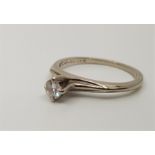 A 14ct. white gold diamond solitaire ring, claw set round cut diamond (weight approx. 0.12