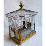 An Edwardian brass bird cage, with slide-in etched glass panels to lower section and twin opaline