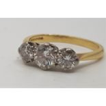 An 18ct. gold three stone diamond ring, set row of three graduated round brilliant cut diamonds (the