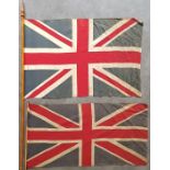 Two Union Jack flags, printed on cloth, 53cm x 80 cm and 42cm x 80cm. (2)