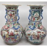 A pair of Qing dynasty Chinese vases, decorated in famille rose design of typical form, height 35cm