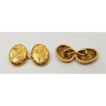 A pair of 18ct. gold oval cuff links, foliate engraved to faces, link fitting. (4.7g), in fitted