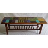 An Ercol style coffee table, with 1970's period tiled top, length approx. 116cm, height 39.2cm..