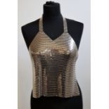 **WITHDRAWN**A chain mesh halter top by Noir, with adjustable back and neck chains together with