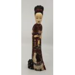 A Chinese Qing dynasty carved and stained ivory of a lady, height 23.5cm.