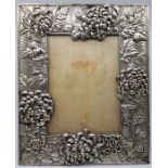 A large Japanese late Meiji period white metal photograph frame, fashioned as chrysanthemum