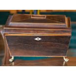 A Regency mahogany tea caddy, fitted interior with a central mixing bowl flanked by twin lidded