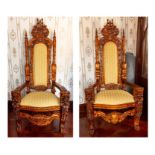 A large pair of thrones, elaborately carved throughout with heraldry and lions heads, upholstered