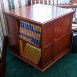 A mahogany revolving bookcase, panelled sides incorporating cupboards, width 64cm Note: located at