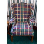 A wing back armchair of Georgian design, tartan upholstered Note: located at the vendor's property