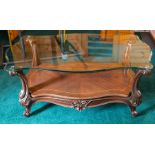 A coffee table with serpentine glass top on cabriole supports, width 112cm Note: located at the
