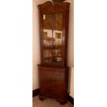 A burr wood corner standing vitrine, serpentine cornice, cupboard below, height 190cm Note: