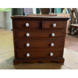 A 19th Century grained pine collectors chest, two short over three long drawers.