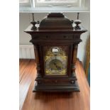 An Edwardian oak bracket clock, of architectural form the domed caddy top with fish scale decoration