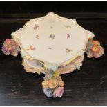 A Meissen porcelain clock stand, early 20th century, cartouche shape with foliate decorations.