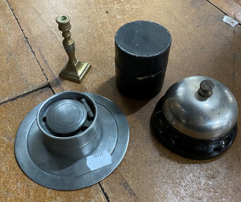 A group of items including desk bell, pewter ink well, miniature brass candlestick and a glass minim