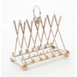 An American silver plated toast rack of golfing interest, of rectangular outline, the arches