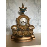 A 19th Century French cast brass bracket clock, of Baroque design, inset porcelain plaques, height