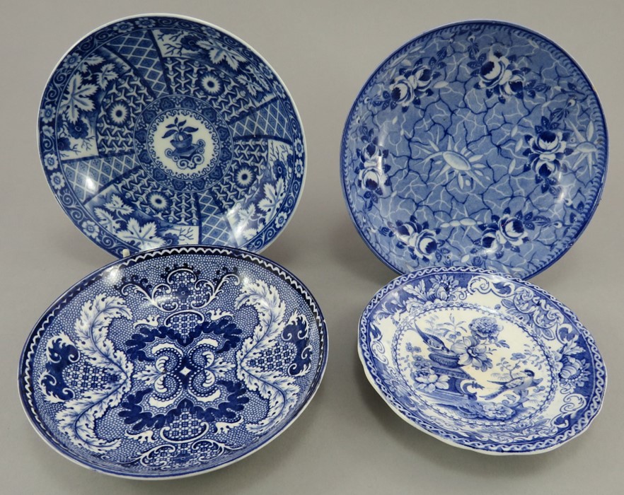 A group of early nineteenth century blue and white transfer-printed saucers, c.1820-30. To