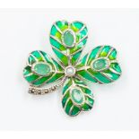 A plique a jour silver brooch/pendant in the form of a clover leaf, each leaf set with faceted