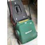 A Qualcast electric lawn mower with grass box.