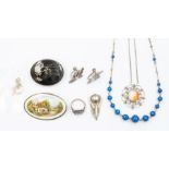 A collection of silver and white metal jewellery to include an enamel oval brooch depicting a