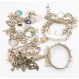A collection of vintage silver and white metal jewellery to include two silver charm bracelets,