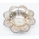 An Edwardian silver floral shaped bowl, with shaped border raised on circular foot, by Atkin