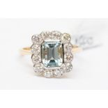 An aquamarine and diamond 18ct gold ring, central rectangular cut aquamarine weighing approx. 1.