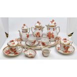 A Herend porcelain cabaret set, decorated with coral coloured flowers and butterflies detailed in