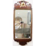 An early 19th Century mahogany mirror with original glass and an eagle and oak leaf detail to the