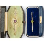 An Edwardian 15ct gold target brooch, the centre set with a round amethyst, with a double open
