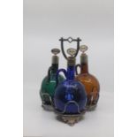 A late Victorian coloured glass decanter set and stand, comprising three bottle decanters with