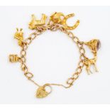 A 9ct gold charm bracelet, seven various charms to include a Bambie, horseshoe, teapot, St