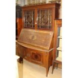 An Edwardian mahogany bureau bookcase, the upper section with two glazed doors enclosing fitted