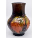 A Moorcroft Flambe 'Leaf and Berry' pattern bulbous shaped bottle neck vase, early 20th Century,