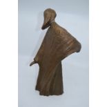 A contemporary bronze abstract figure of a person, stamped LH to the base, 37 cms high approx