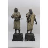 A pair of Austrian cold painted spelter figures of Middle Eastern street performers, each modelled