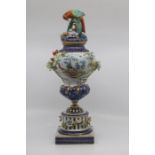A French porcelain Sevres-style vase and cover, of baluster form with parrot finial and raised on