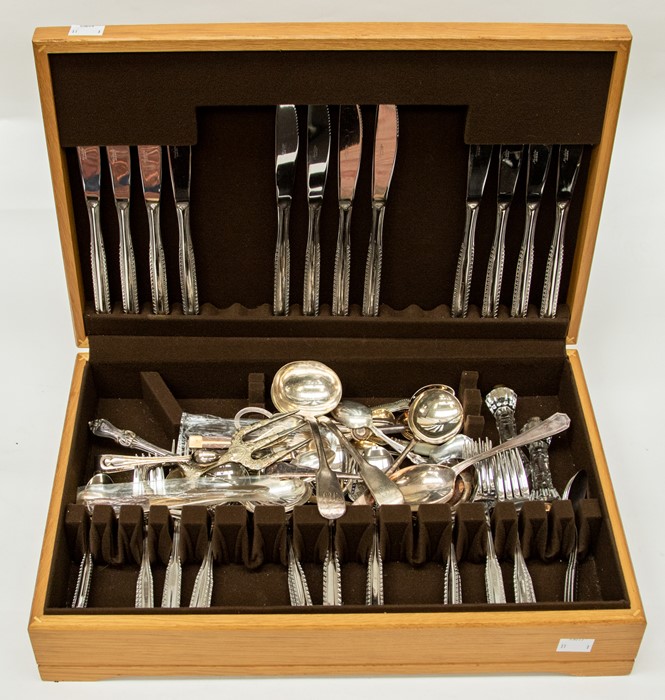 An oak cased canteen of cutlery, by Noritake, in stainless steel, together with further pieces,
