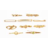 A collection of nine Edwardian 9ct gold brooches, to include stone set versions set with garnet