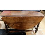 An early 18th Century joined oak gateleg table, raised on bobbin turned supports