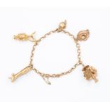 A 9ct gold charm bracelet  with five assorted charms to include a Grandfather clock, chamber