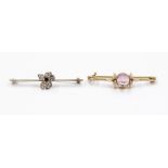 An amethyst and enamel 15ct gold bar brooch,  comprising a central round cabochon cut amethyst