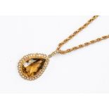 An Edwardian and pearl 9ct gold pendant, pear cut citrine set to the centre approx. 12 x 18mm,