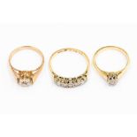 Three diamond rings to include an 18ct gold solitaire, size J1/2, a five stone 18ct gold ring with