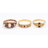 A collection of three late 19th early 20th Century gold rings to include: an 18ct gold ruby and half