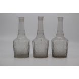 A set of three Bohemian glass armorial decanters, 19th Century, of mallet shape with faceted bodies,